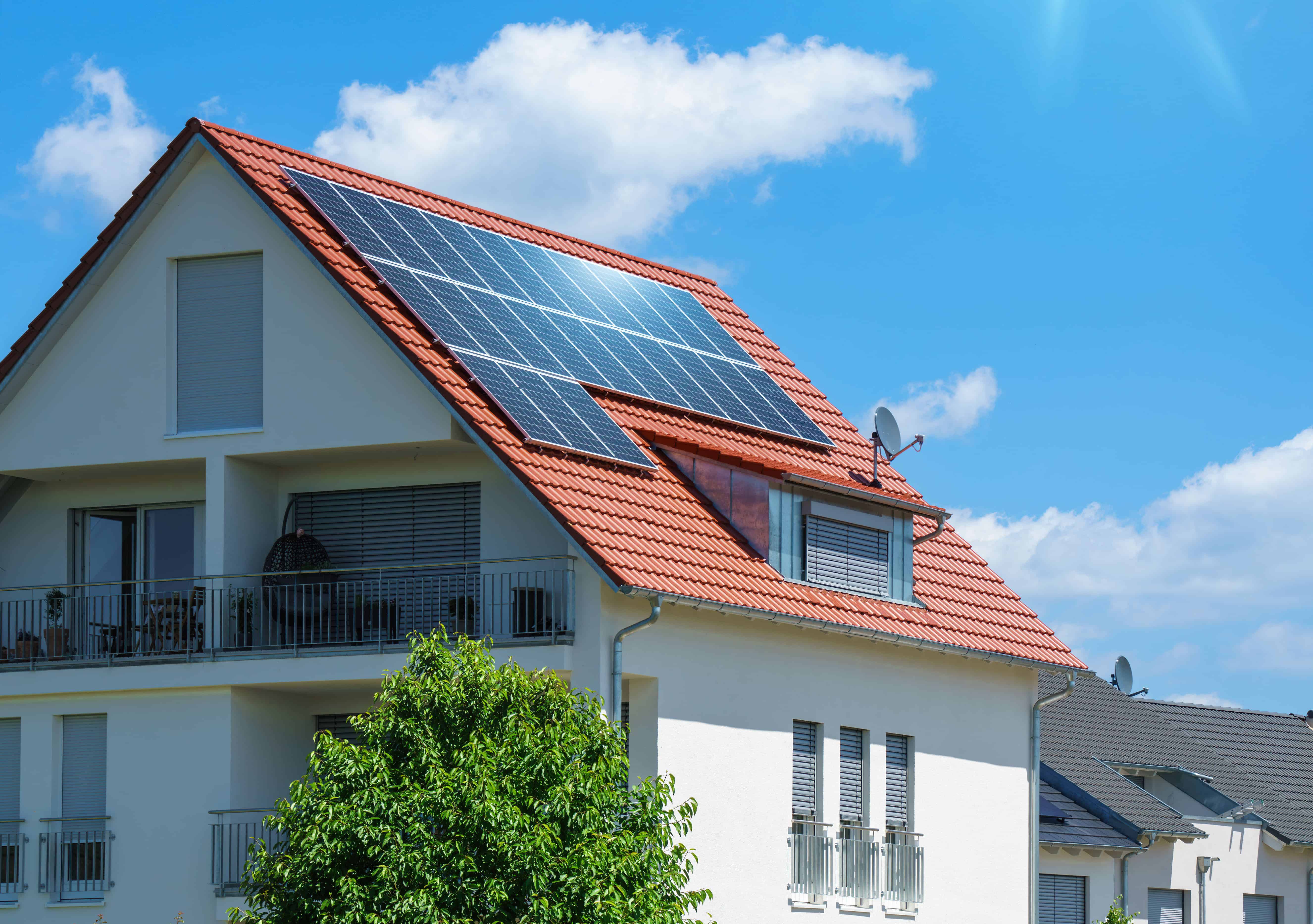 Home with Solar Energy Green Plants Sunny Blue Sky Image